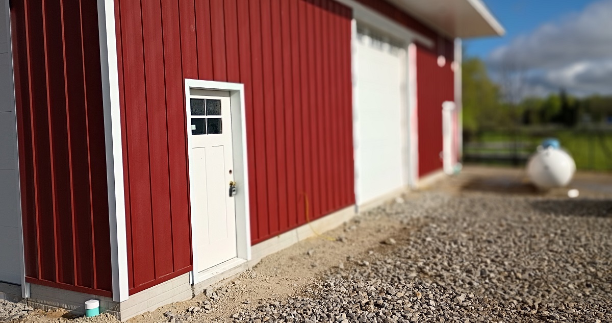 Steel board and batten siding Rustic Red close-up on custom barn in Manitou Beach Michigan